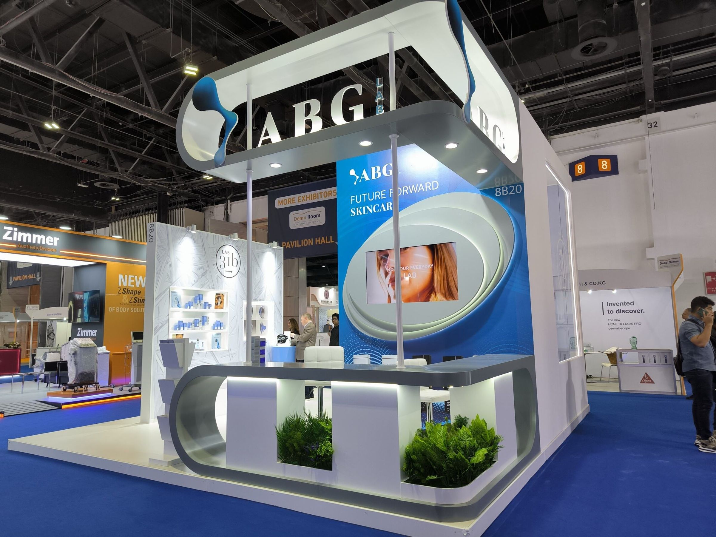 Exhibition booth with a curved branded wall and product display counters