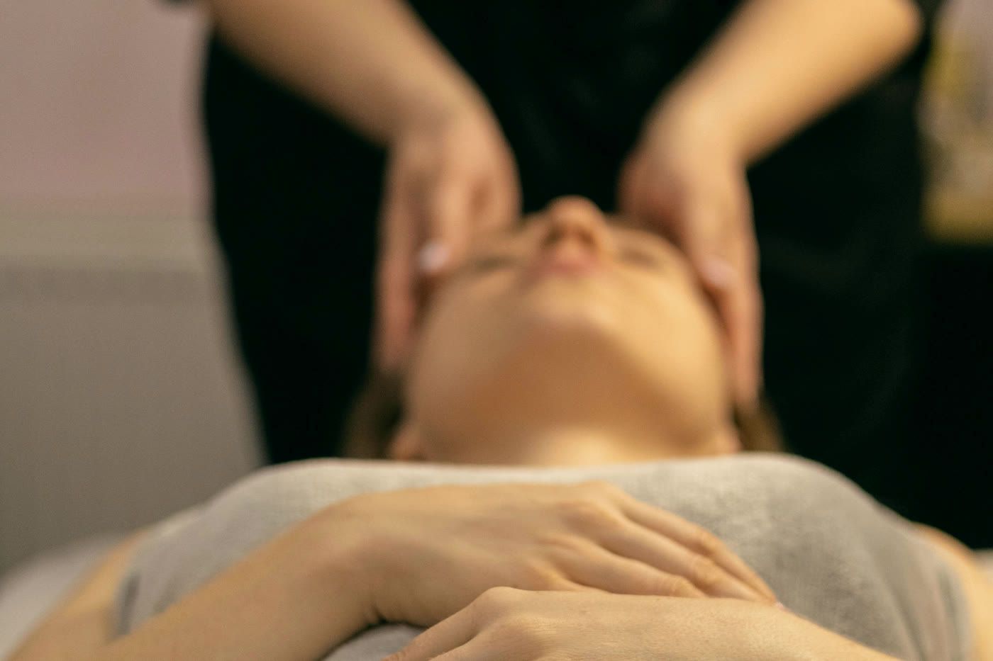 A massage therapist working on a patient's neck and shoulders