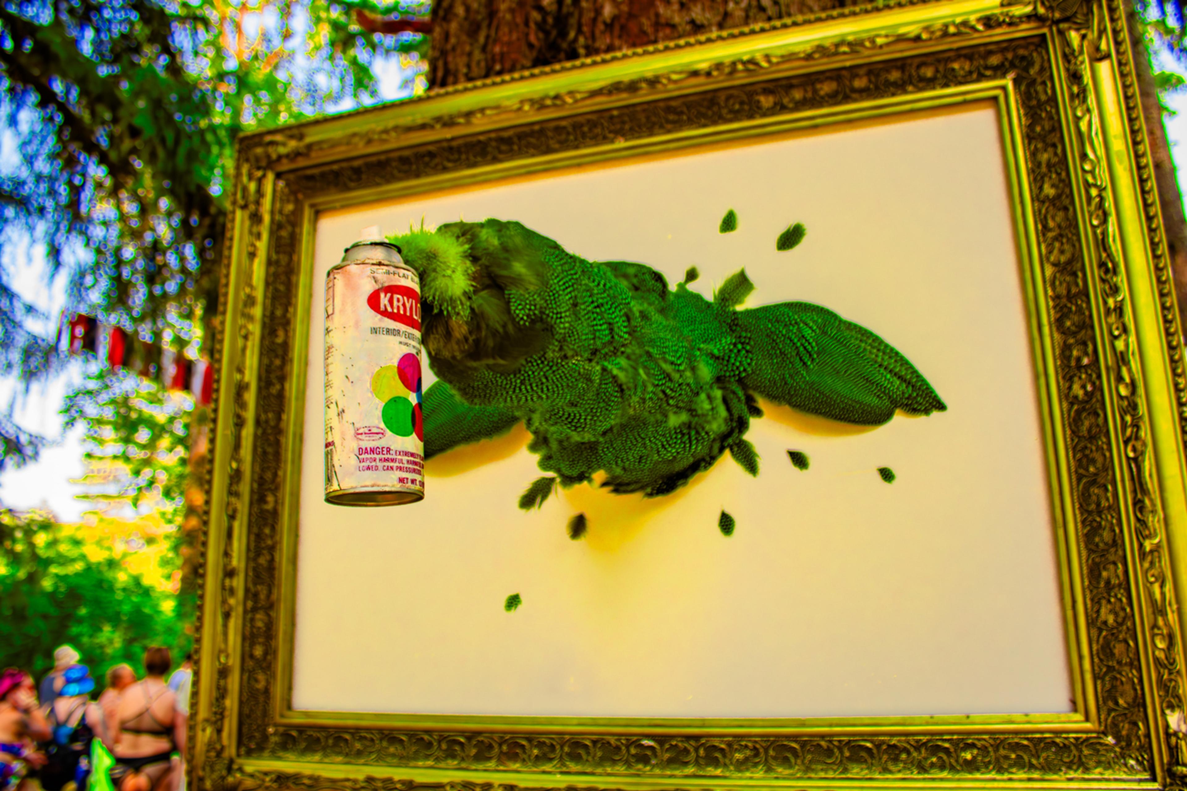 Mixed media art a vintage spray paint can, displayed outdoors at a festival.