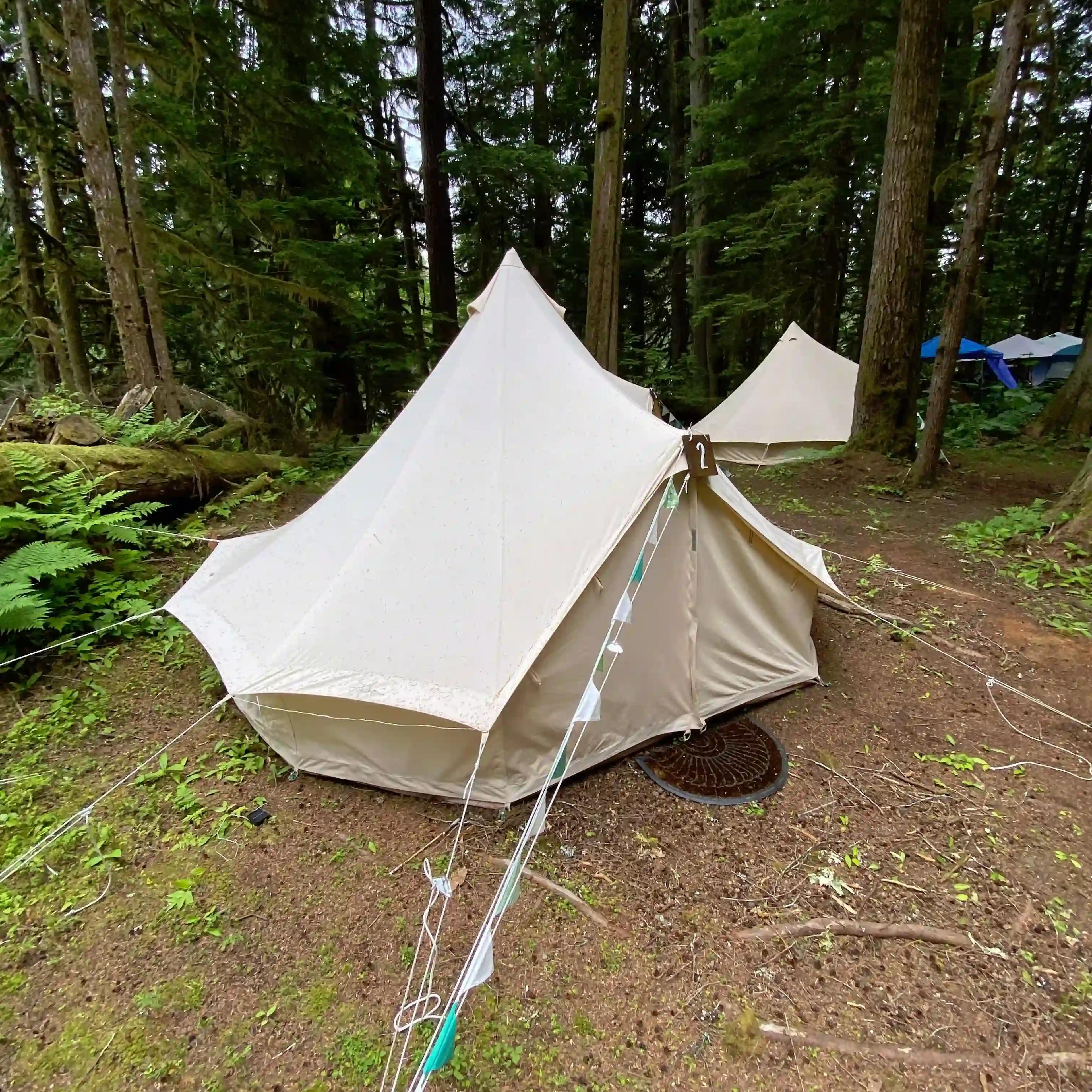 White canvas bell tent set up at ValhallaFest