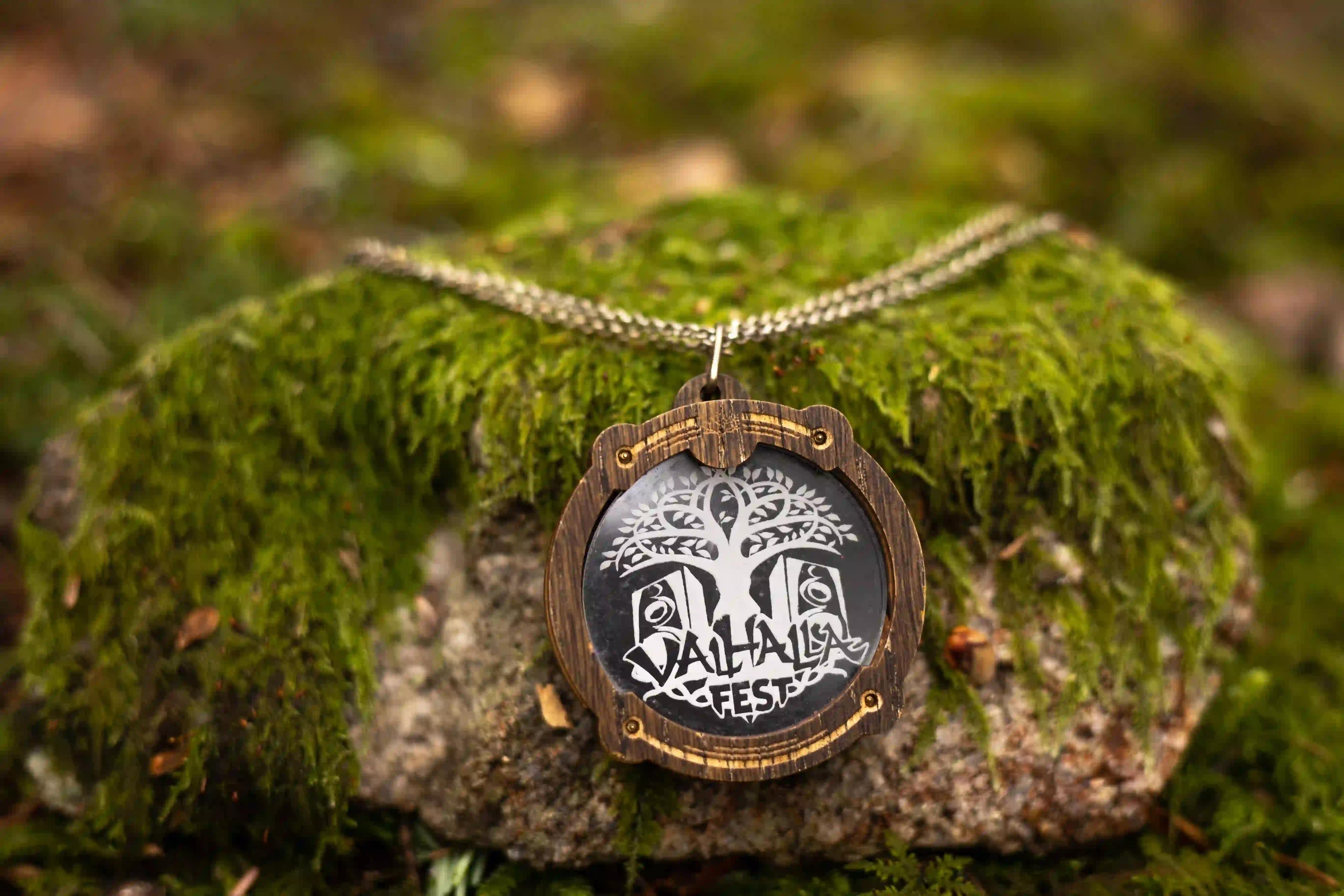ValhallaFest wooden pendant necklace on a mossy rock