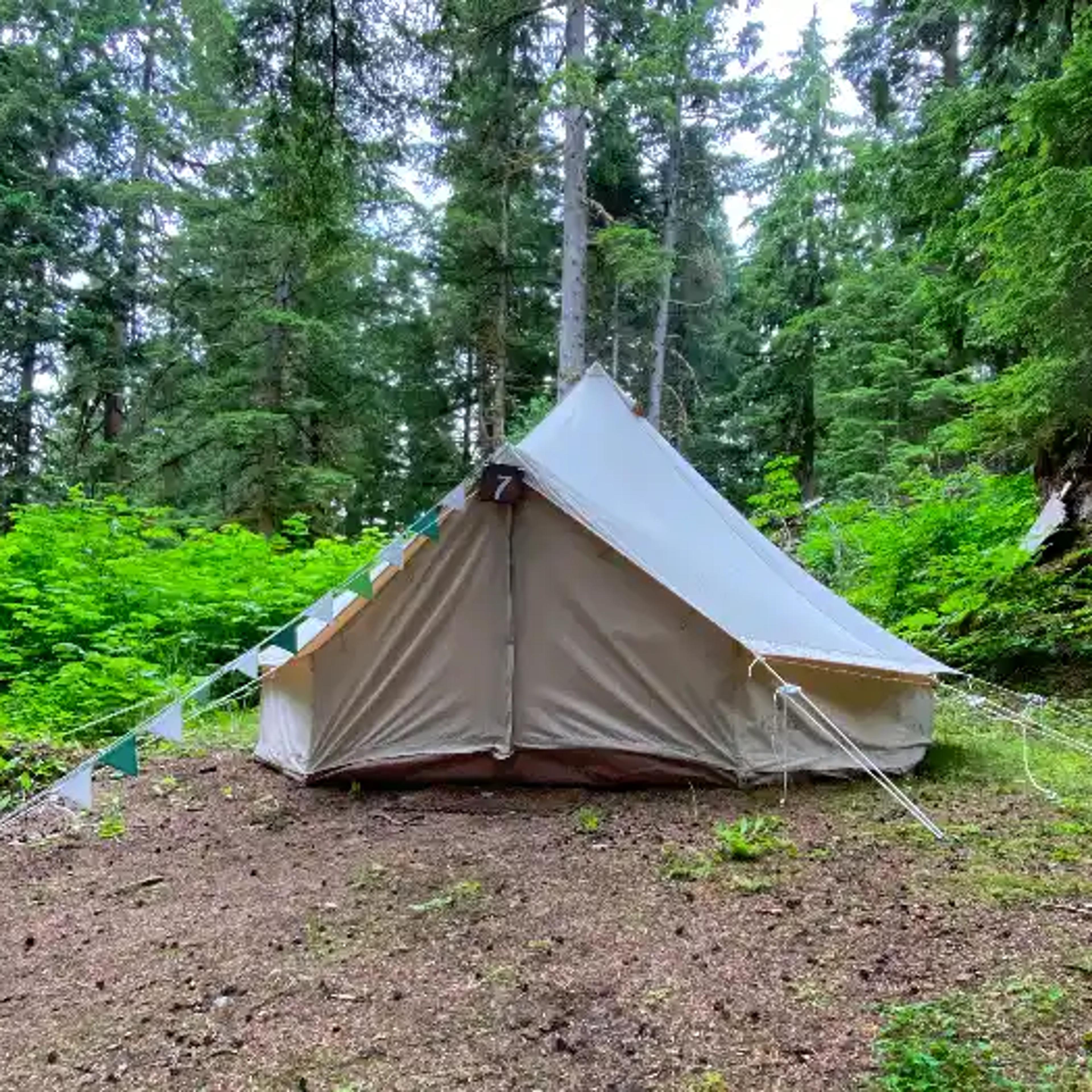 White canvas bell tent set up at ValhallaFest