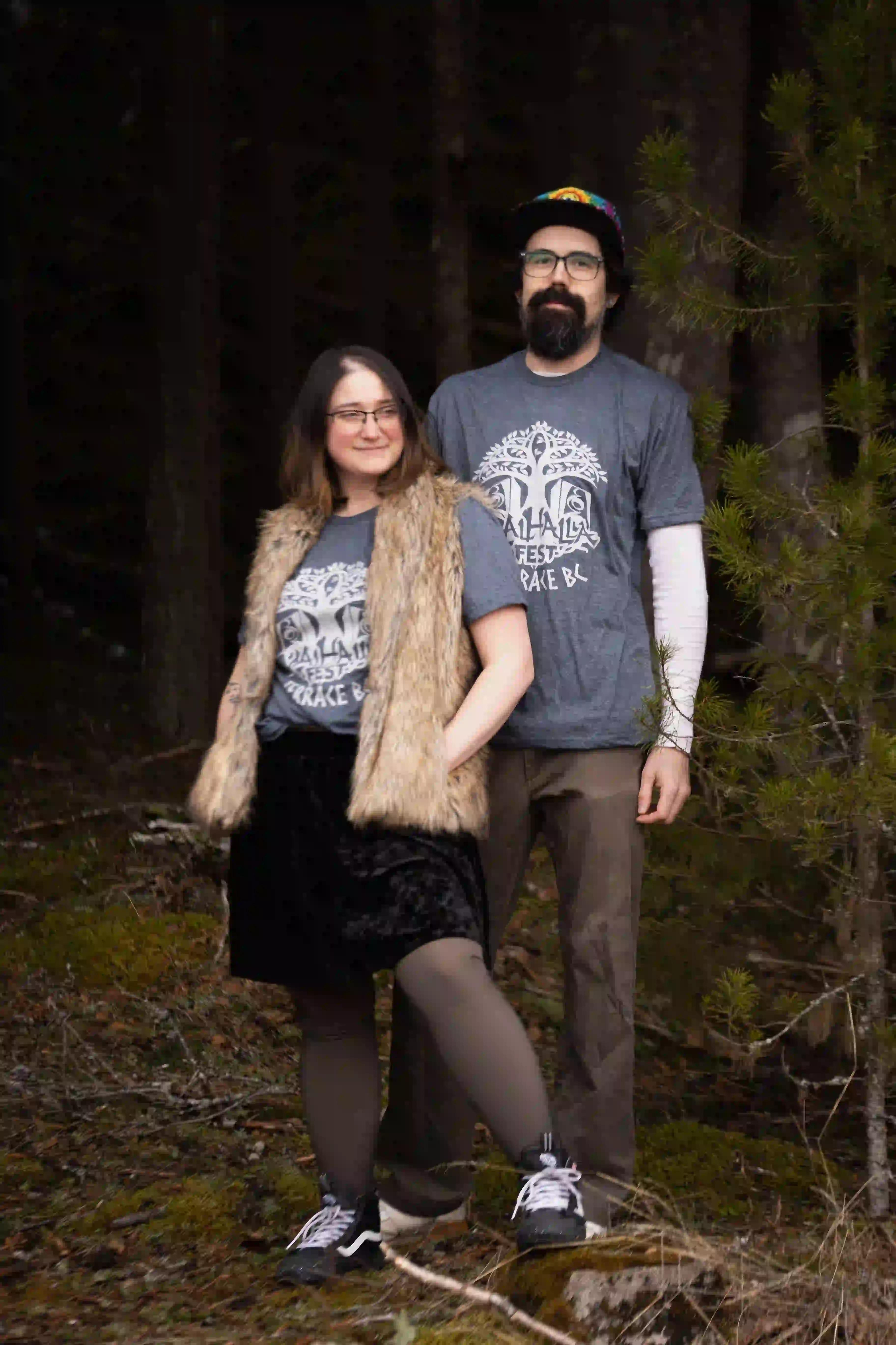 Couple wearing matching ValhallaFest t-shirts in BC forest