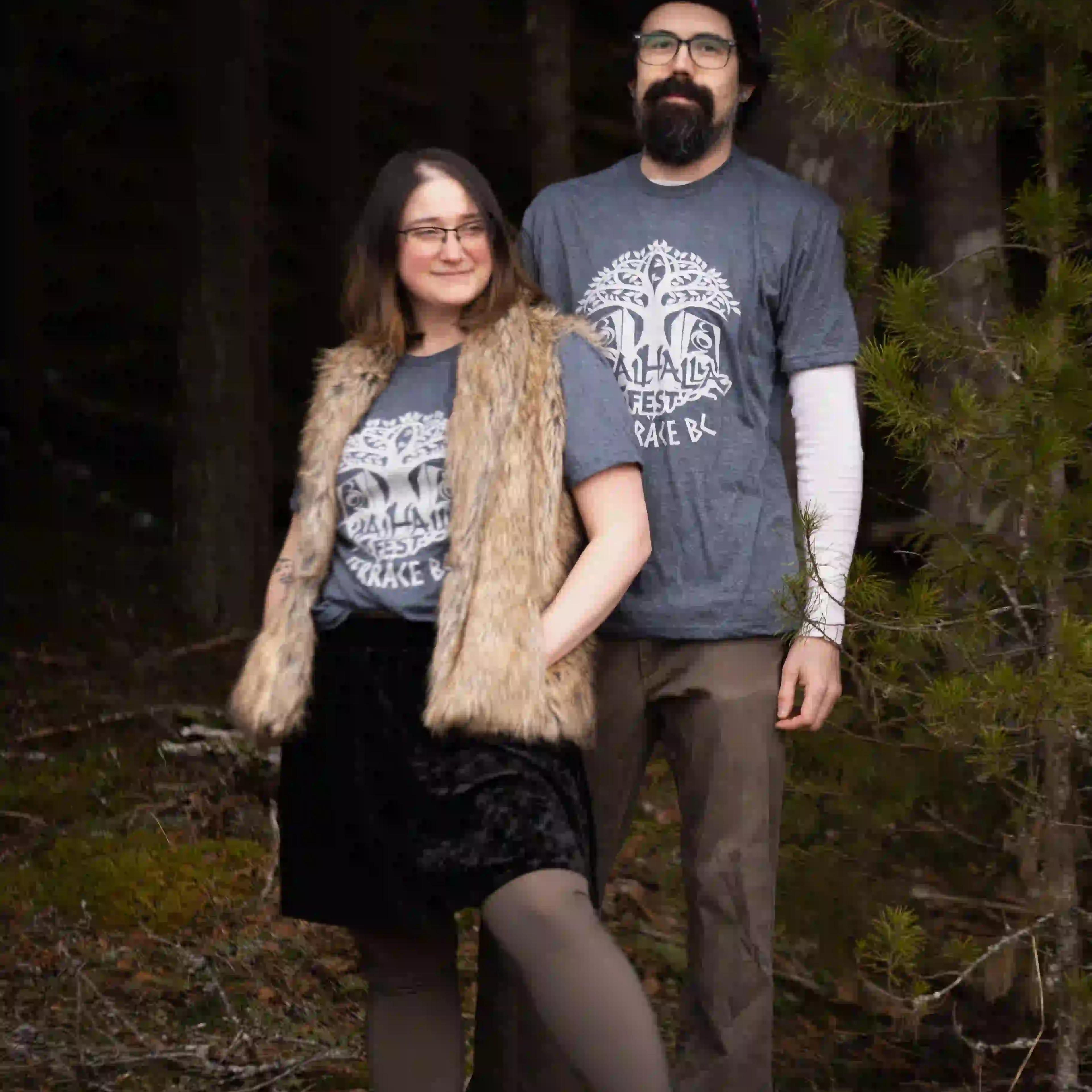 Couple wearing matching ValhallaFest t-shirts in BC forest