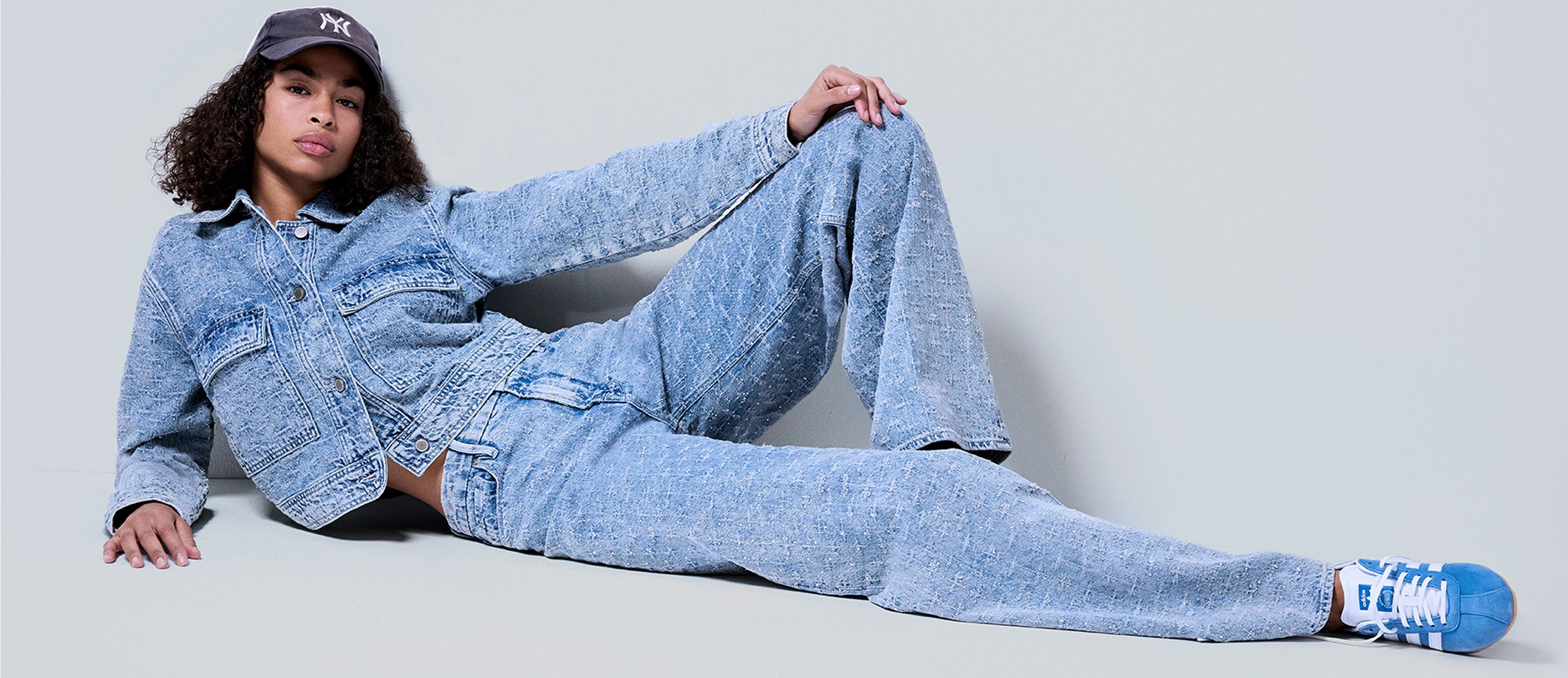 woman wearing crystal jacket and jeans