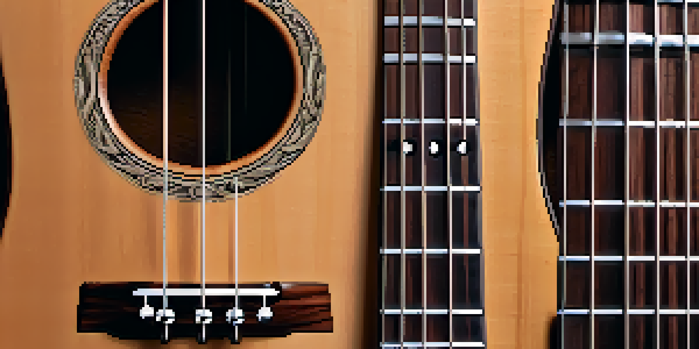 A detailed close-up of a mahogany ukulele neck, highlighting the wood grain and smooth finish, with visible silver frets on a rosewood fretboard.