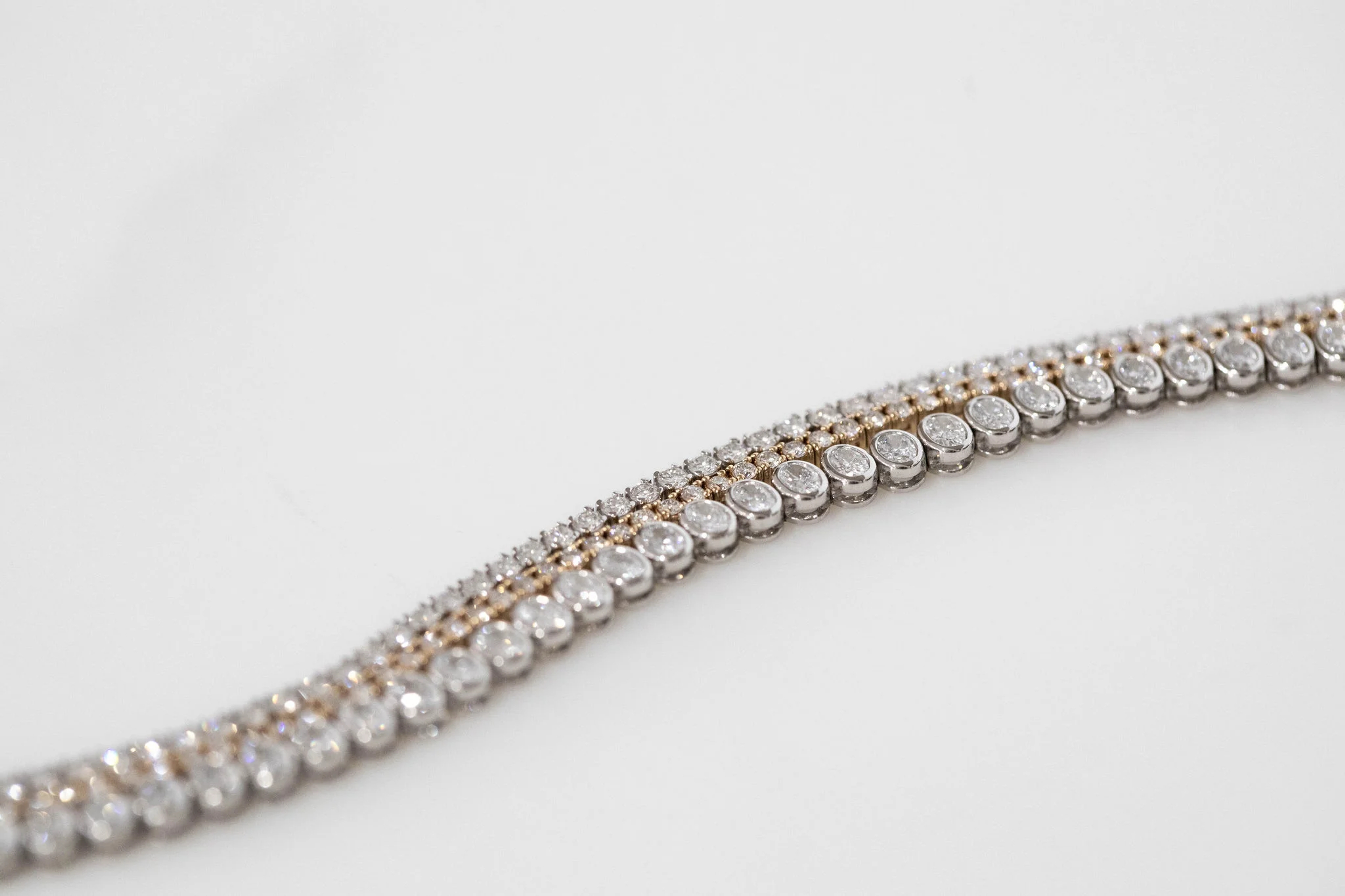 a close-up of a diamond necklace against a plain white background