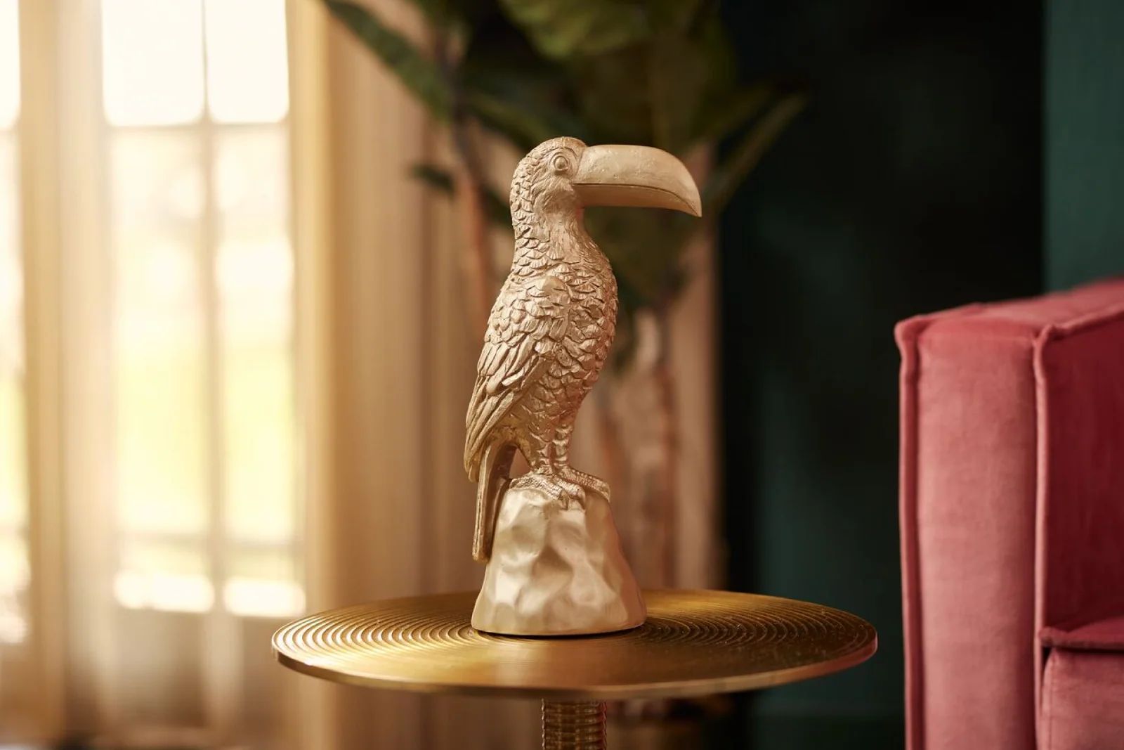Gold toucan statue on a side table