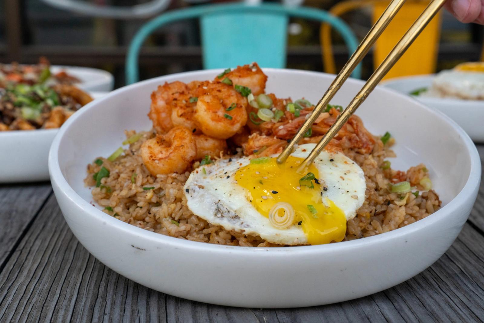 Chopsticks lifting a bite for the camera