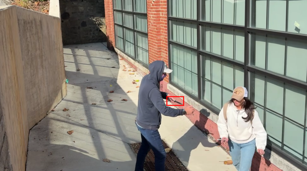 Security camera frame showing brandished knife detection