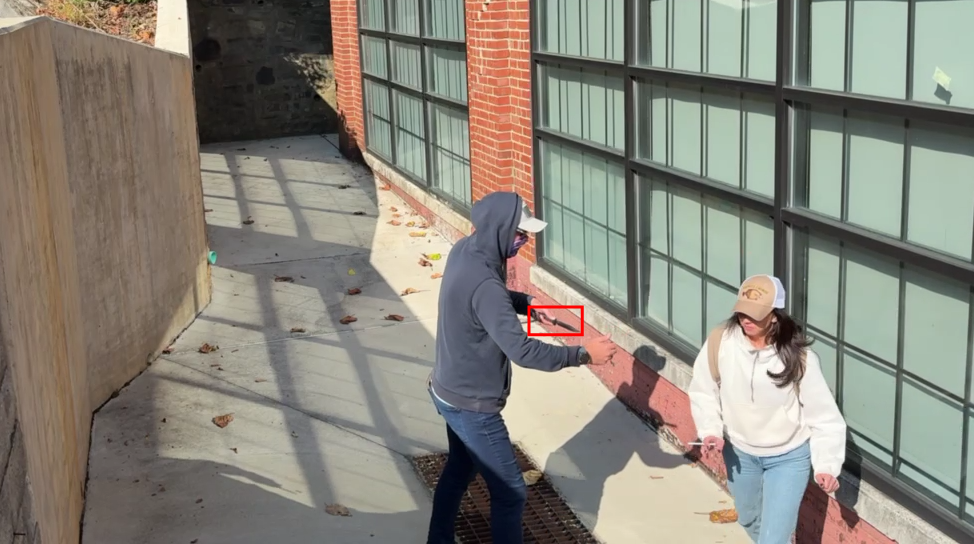 Security camera frame showing brandished knife detection
