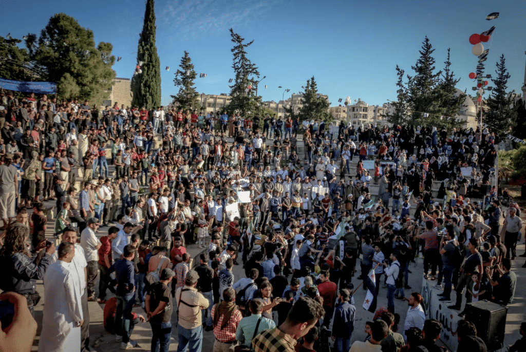 a large crowd of people are gathered in a park