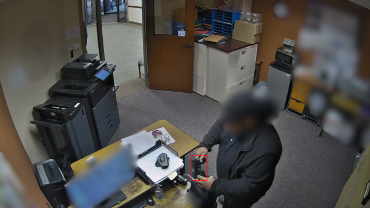 Security camera frame showing brandished firearm detection