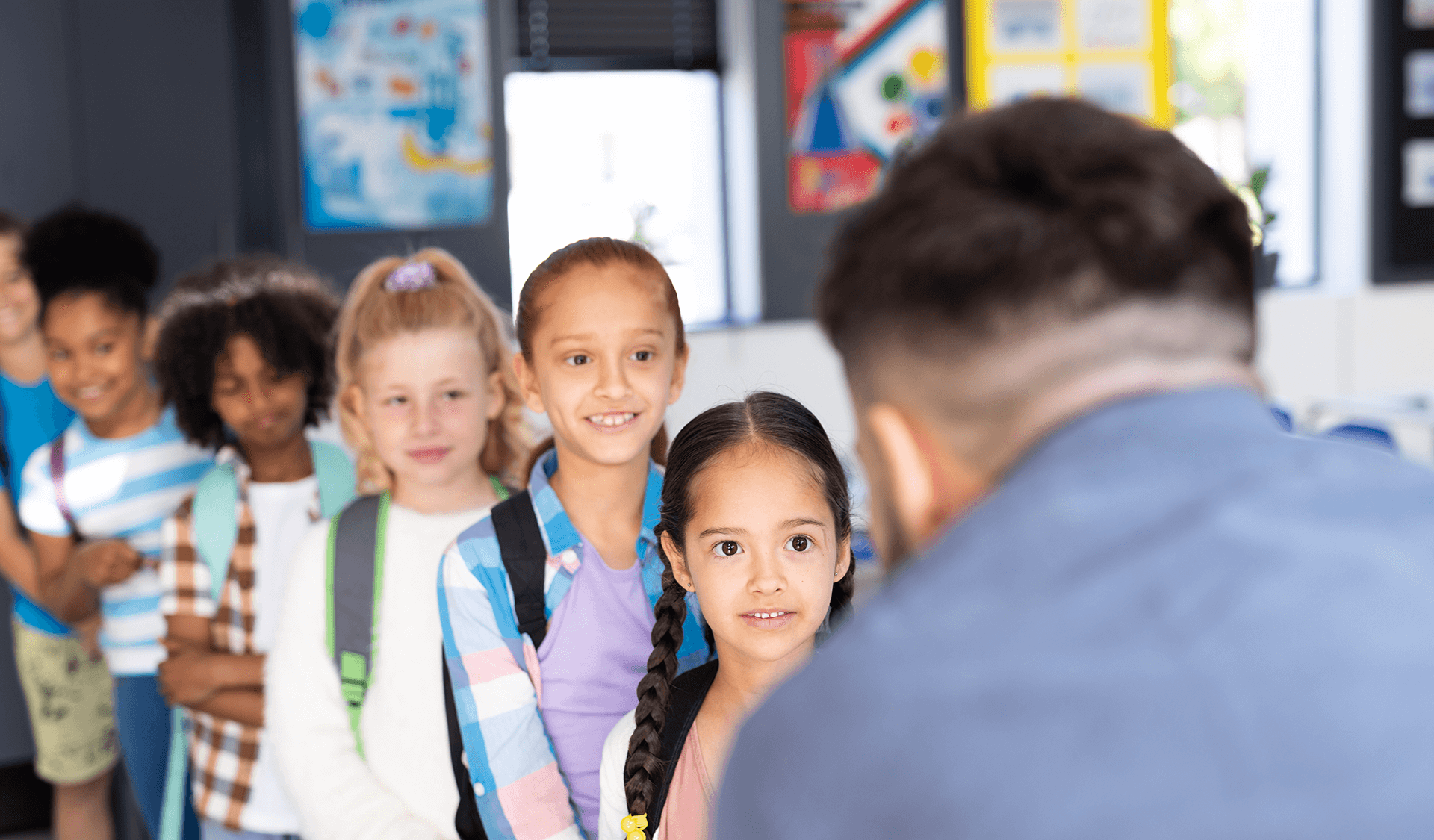 a group of children are standing in a line with their teacher