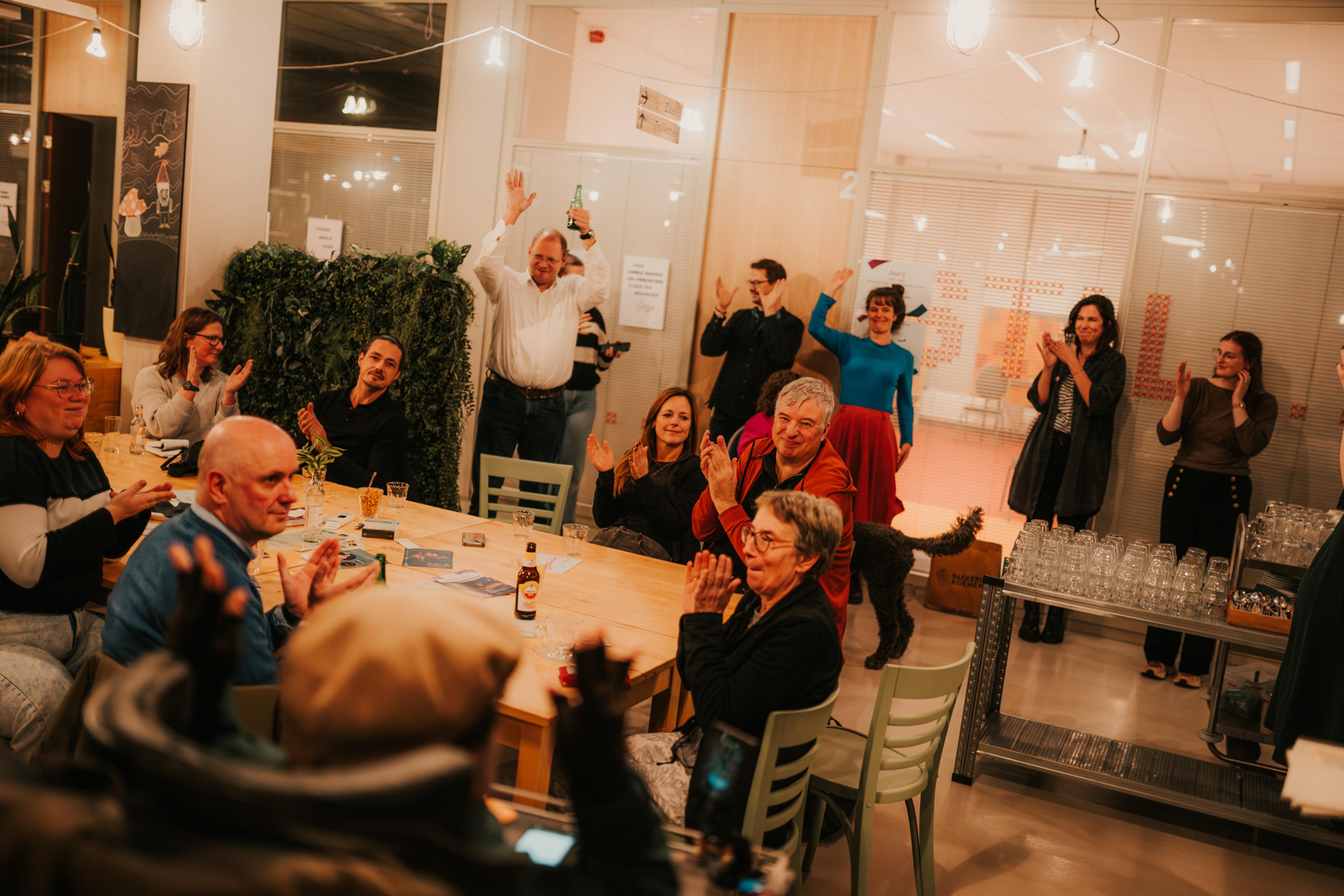 People clap their hands standing and sitting down