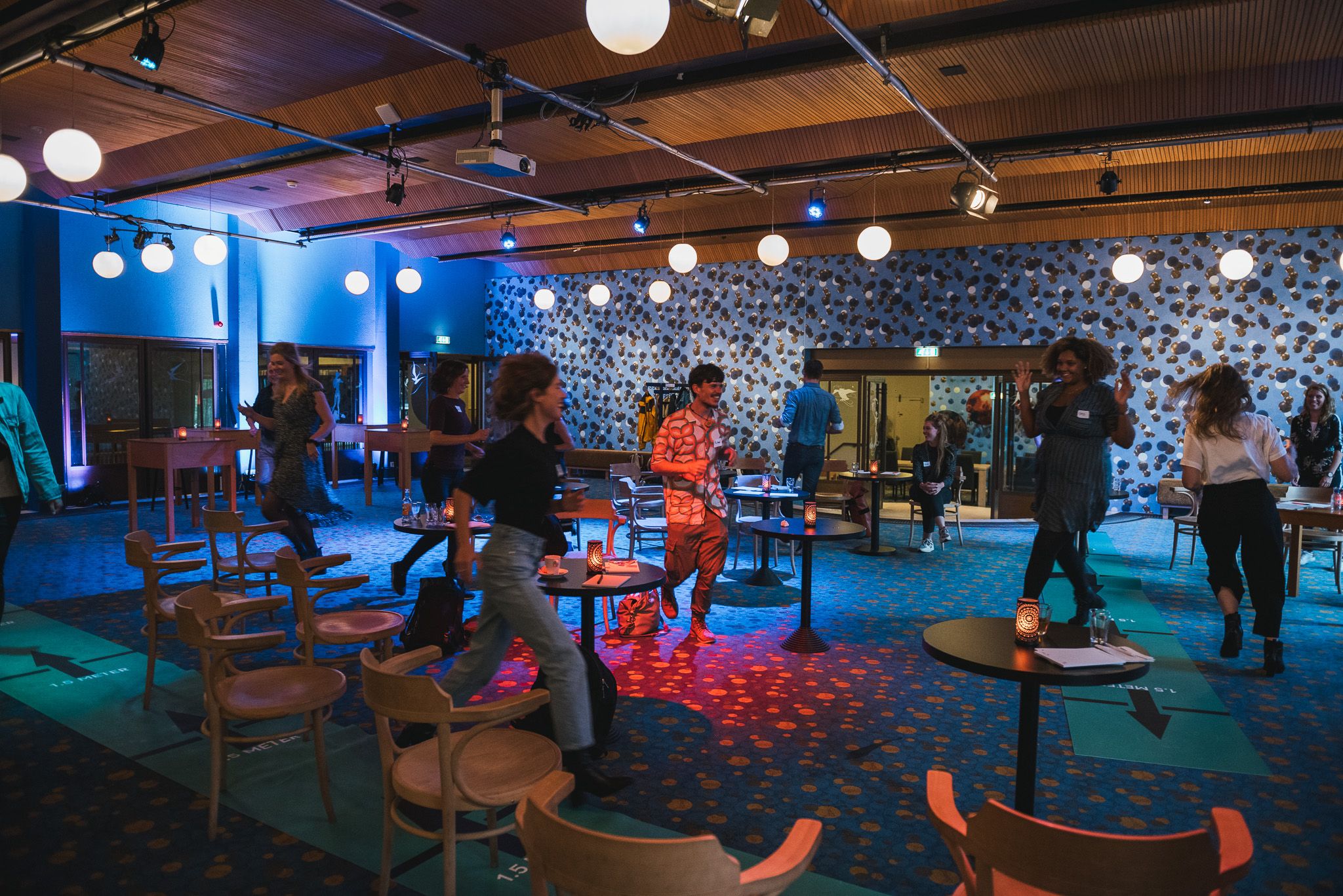 Photo of group of people walking through a hall