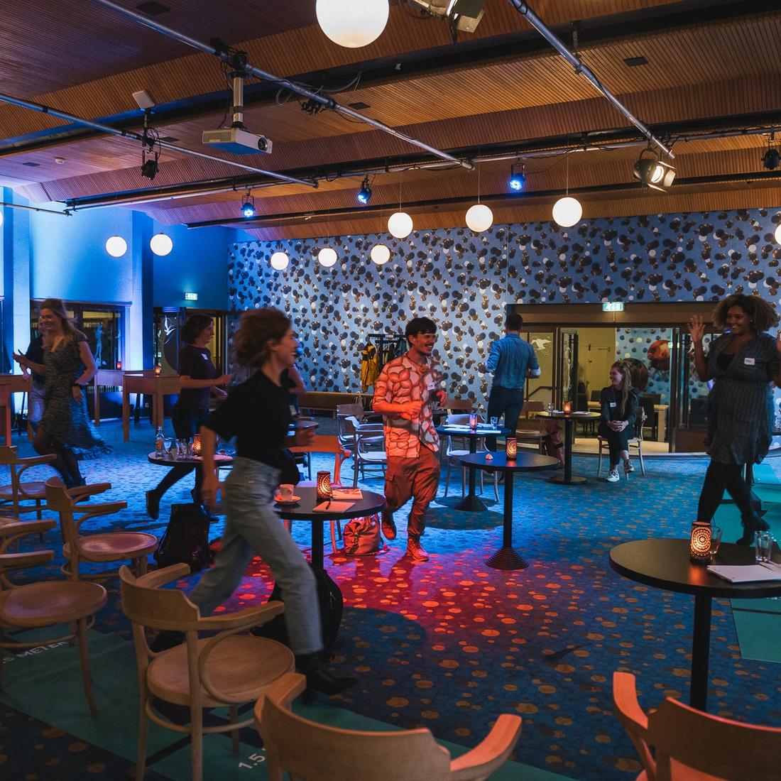Photo of group of people walking through a hall
