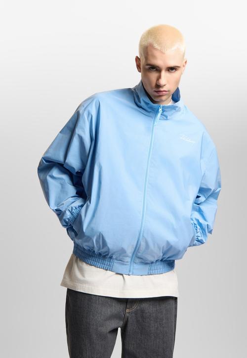 Men's blue jacket on-model photography in studio — menswear ecommerce GoPackshot