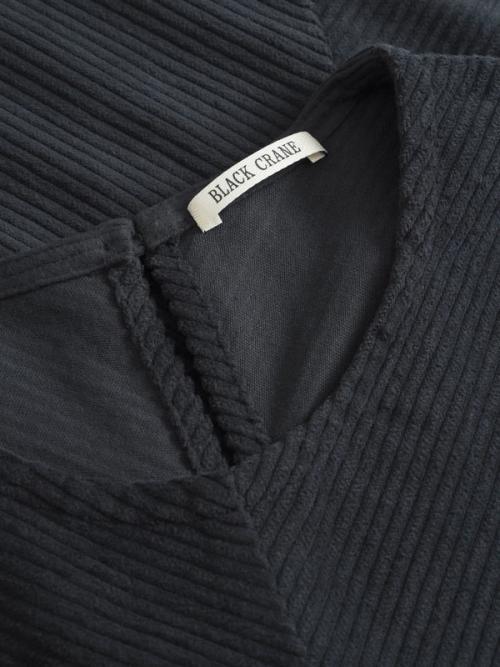 Top collar label detail close-up photography — womenswear ecommerce studio GoPackshot