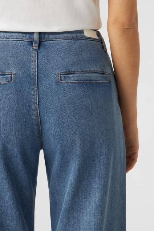 Jeans welt pocket detail on model — macro studio GoPackshot