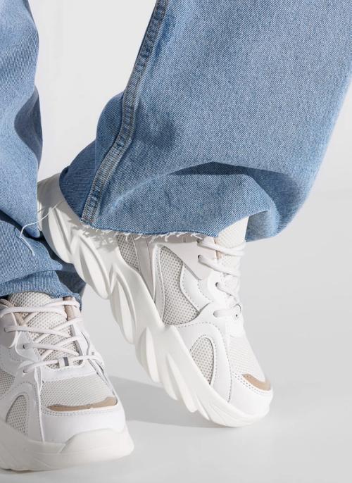 Sneaker on-model close-up with denim styling detail — GoPackshot studio