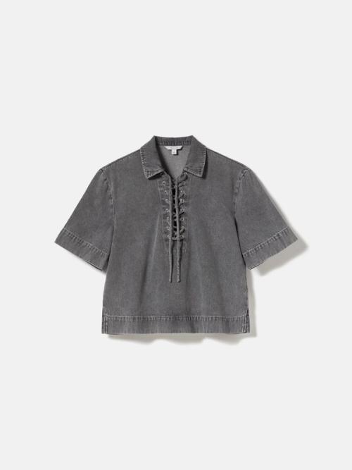 Denim top flat-lay on light background — packshot GoPackshot