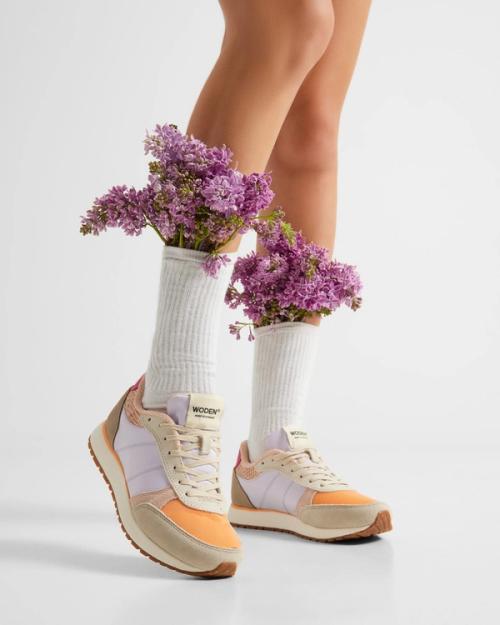 Sneaker lifestyle photography with floral props styling — ecommerce studio GoPackshot