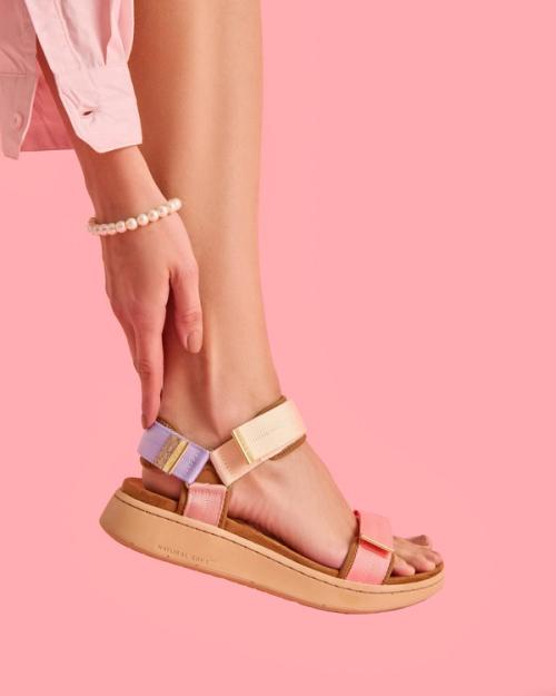 Sport sandal on-model photography with pink studio backdrop — GoPackshot