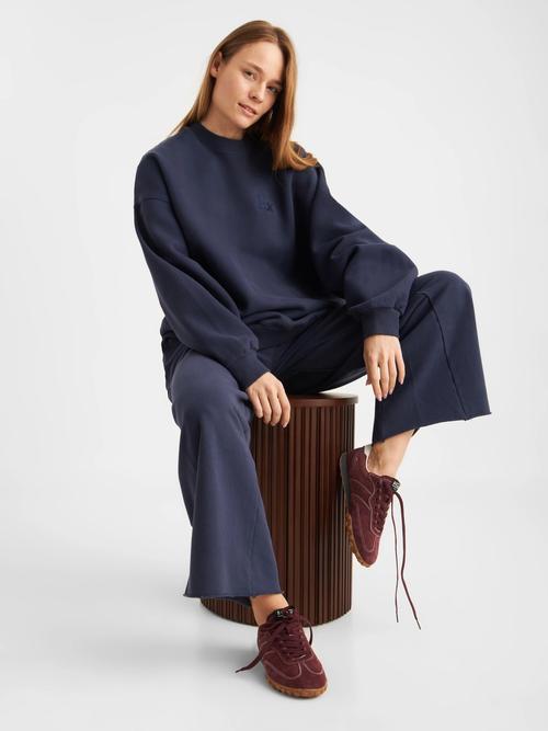 Navy loungewear set on-model photography in seated pose — womenswear GoPackshot