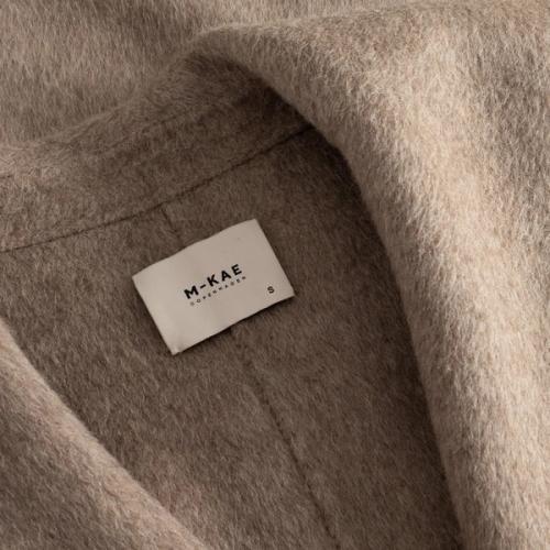 Coat interior label detail close-up photography — womenswear ecommerce GoPackshot