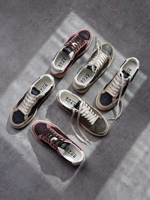Sneaker collection flat lay photography on concrete — footwear ecommerce GoPackshot