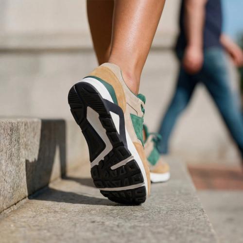 Sneaker urban lifestyle photography walking on city steps — GoPackshot