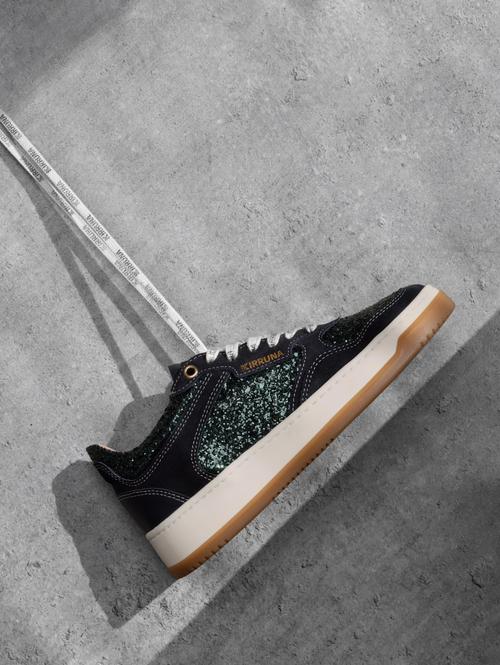 Black glitter sneaker creative photography on concrete — GoPackshot studio