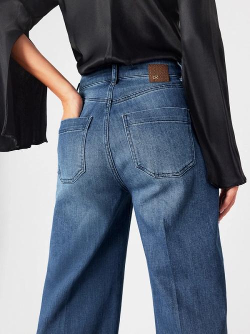 Jeans back pocket and brand patch — on-model detail GoPackshot