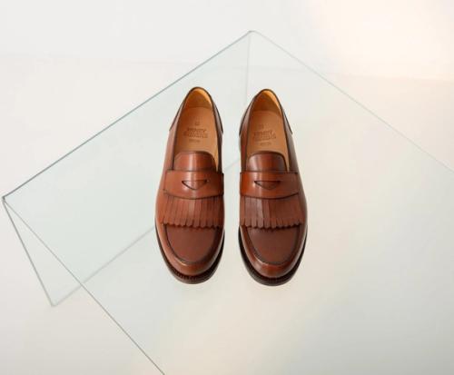 Loafer pair top-view packshot on glass surface — GoPackshot studio