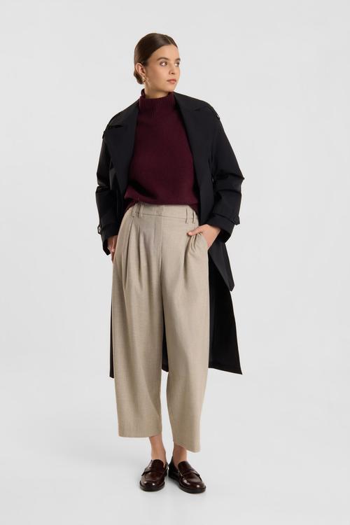 Pleated trousers on-model photography with coat styling — womenswear GoPackshot