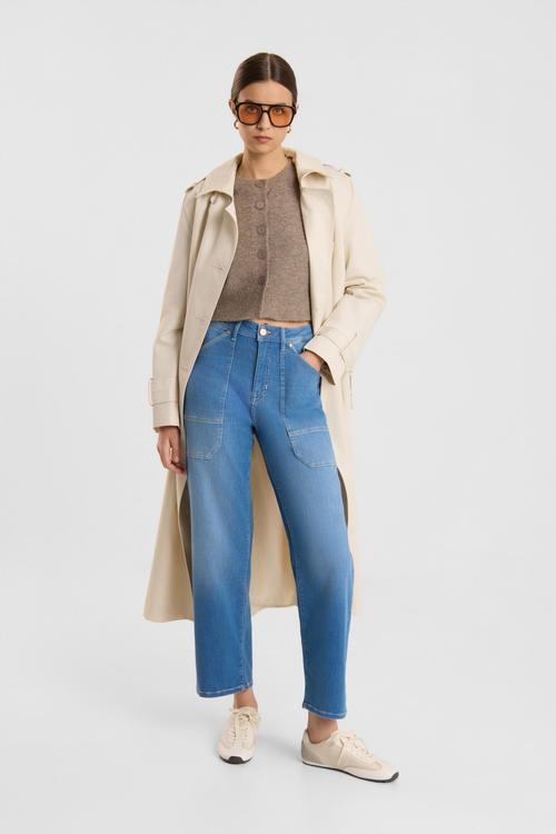 Blue jeans on-model photography styled with trench coat — denim ecommerce GoPackshot