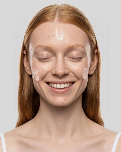 Skincare cream applied on-model in close-up beauty photography — GoPackshot studio