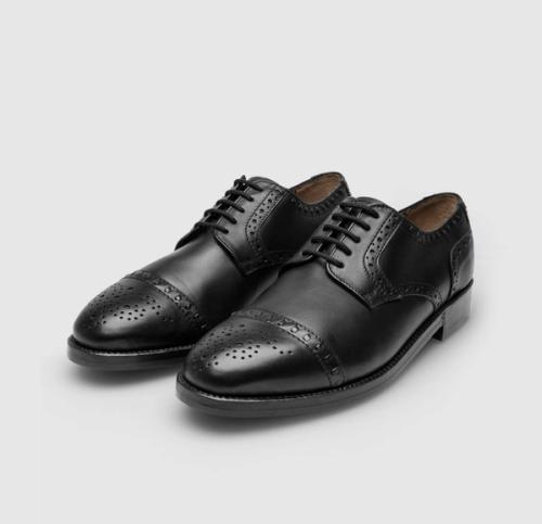 Derby pair packshot with brogue detail on grey background — GoPackshot studio
