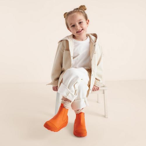 Kids rubber boots on-model photography in seated pose — footwear GoPackshot