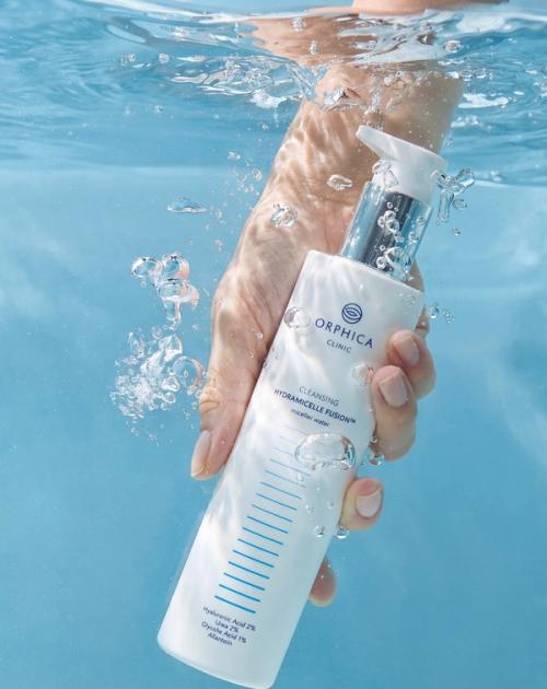 Cleansing foam bottle creative packshot submerged in water — GoPackshot studio