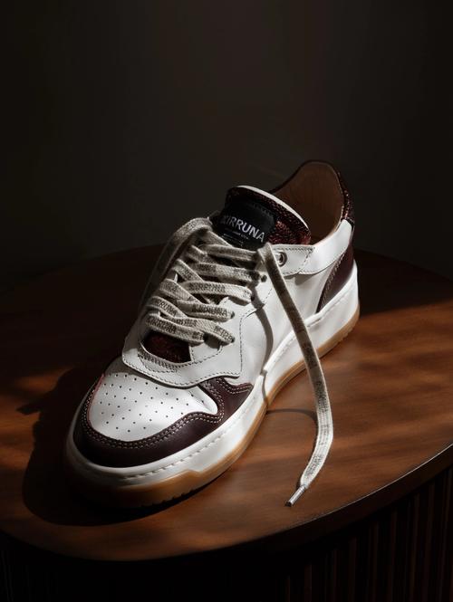 Sneaker creative photography on wooden surface in warm light — GoPackshot studio