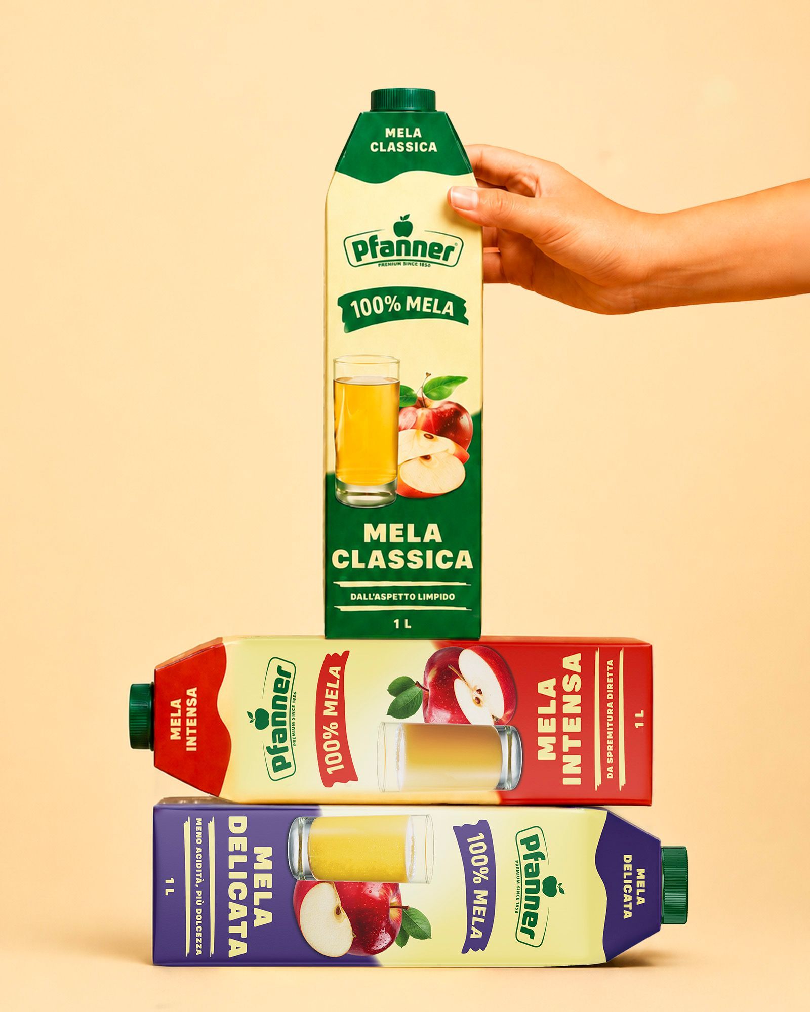 Three stacked Pfanner Mela packs — Classica, Intensa, and Delicata — with a hand supporting the top pack, on a beige background