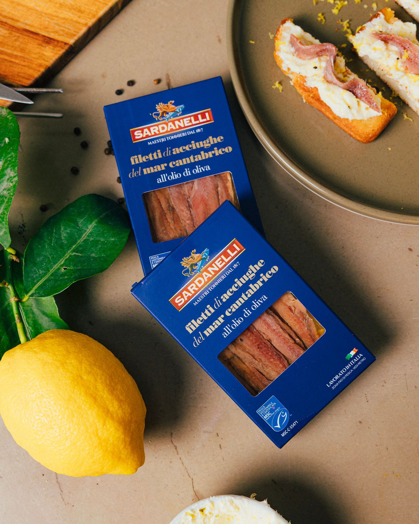 An open pack of Sardanelli bluefin tuna belly in olive oil, surrounded by black product boxes.