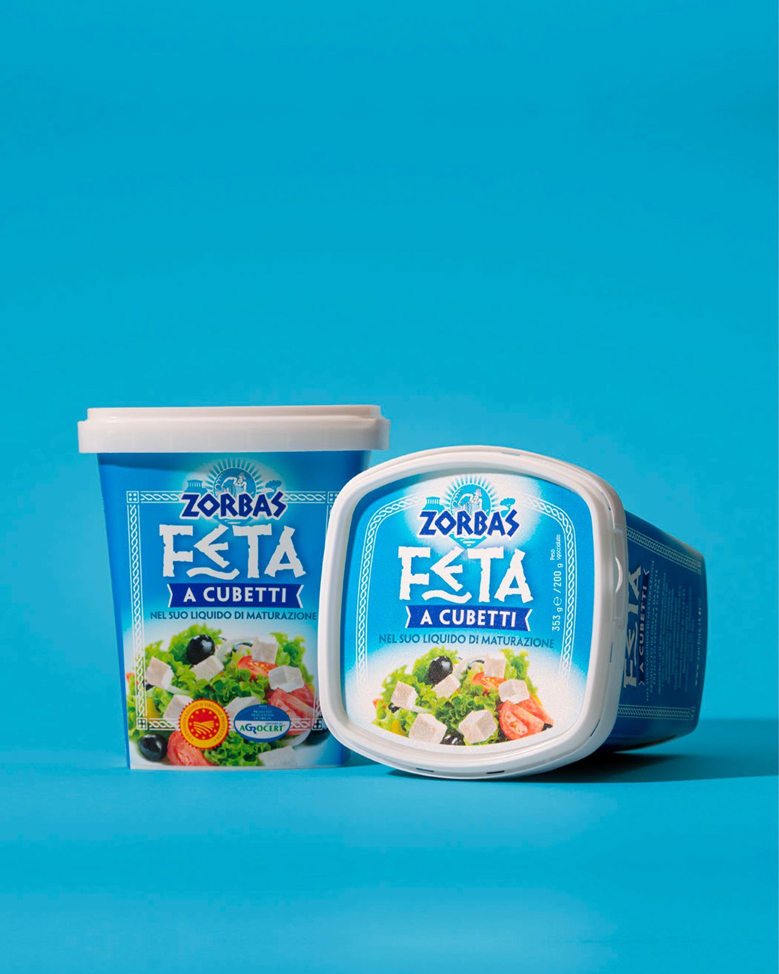 Three stacked packs of Zorbas 100% sheep's milk Greek yogurt on a light-blue background.