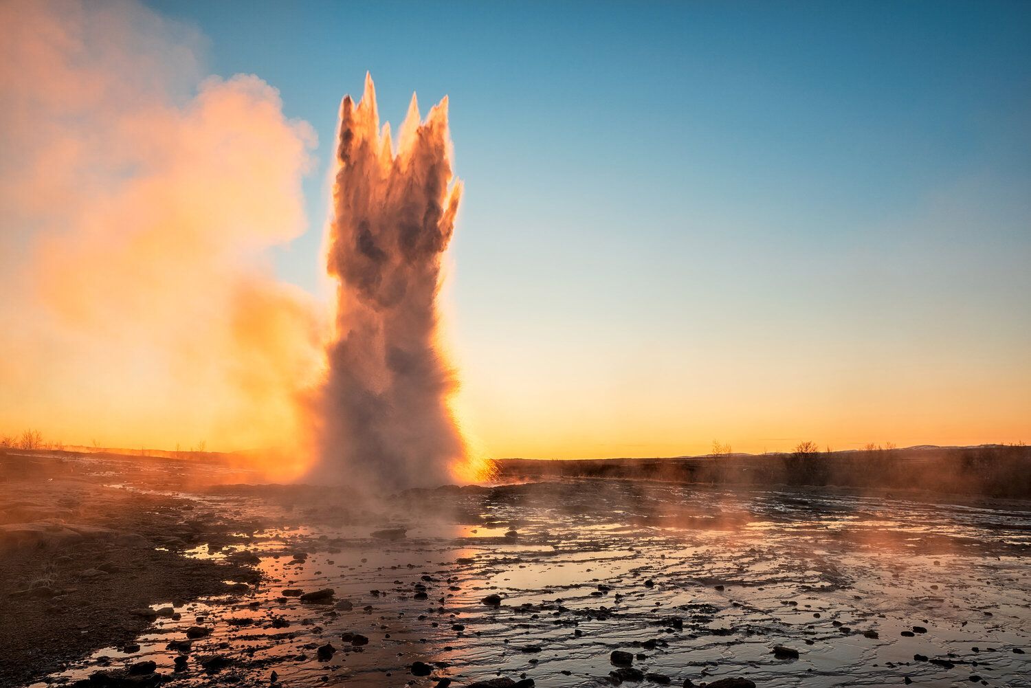 Eruption of the Geysir in Iceland During the Sunrise