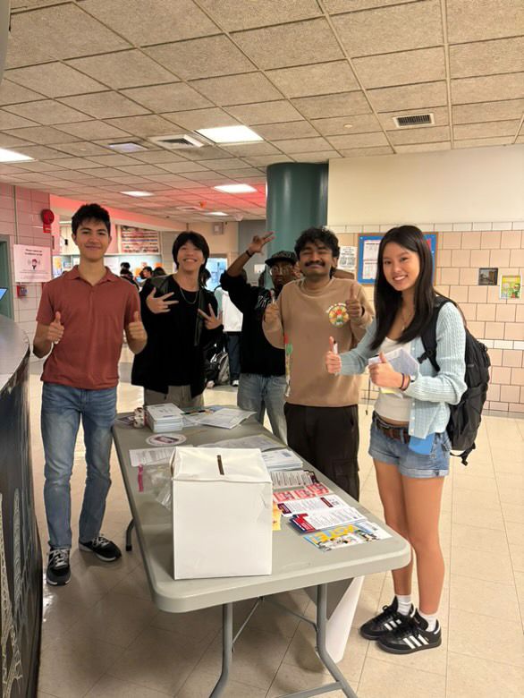 A Vote of Teens organizer talking with a student