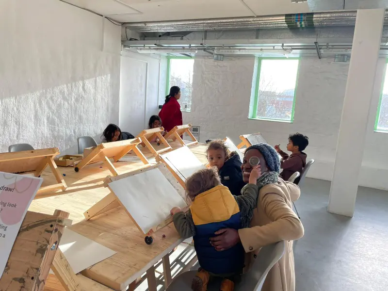 children-and-adults-drawing-together-in-a-bright-modern-art-studio