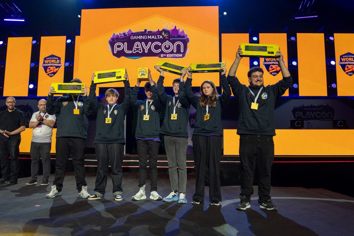 The Minecraft 13+ medallists holding their trophies on stage