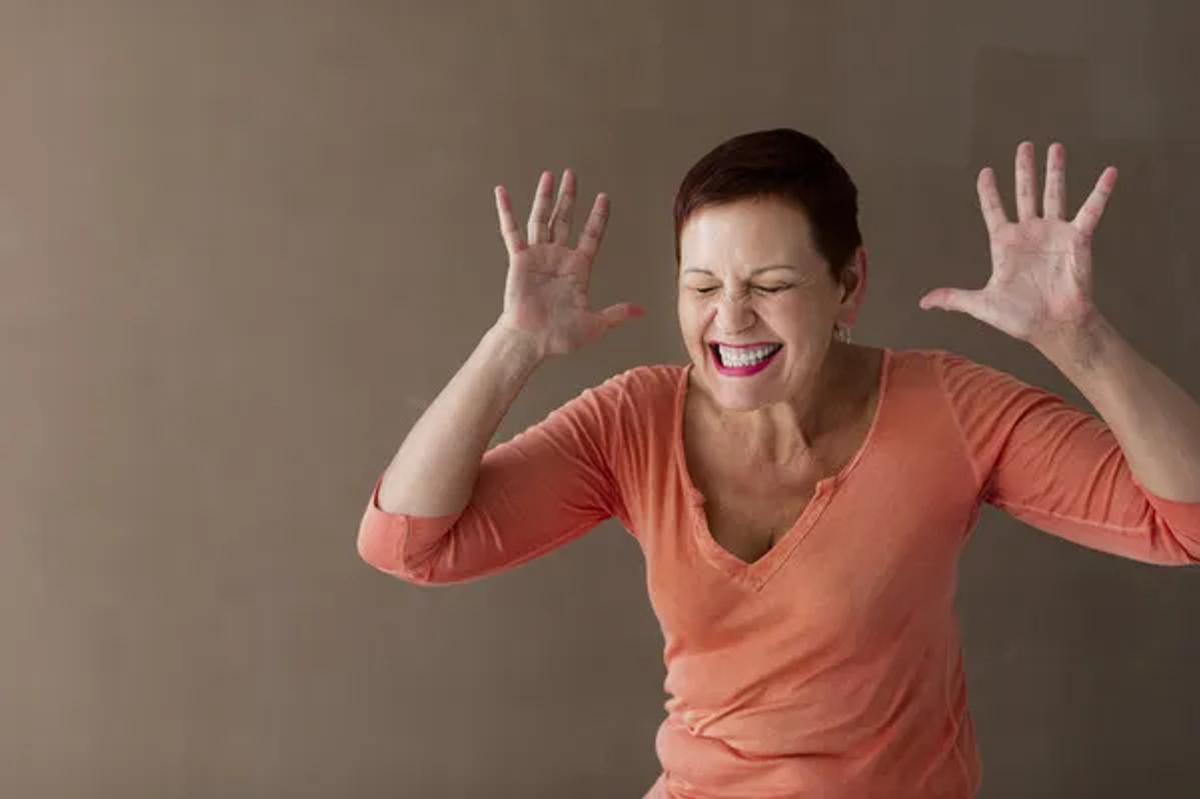 angry woman squeezing a piece of paper